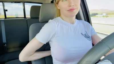 Cute girl taking off bra while driving