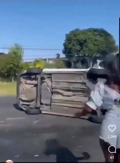 Crowd tries to flip car back over after a car accident