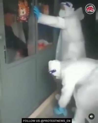 "You Can't Leave". Police in Shanghai drilling doors shut at a restaurant, so nobody can leave.