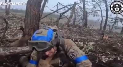 An American volunteer from the "Kenobi Death Korps" unit (1st Battalion of the International Legion) resques a wounded Canadian volunteer in Ukraine