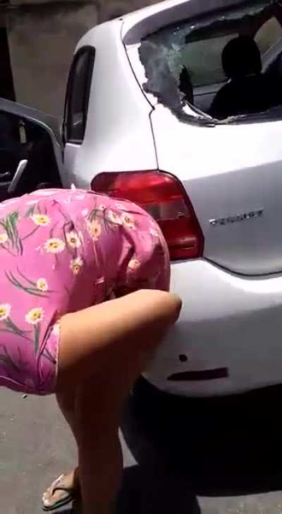 Armed robber tries to rob lady and she gets in a gun fight with him. Robber peppered her car with bullets while she peppered him.