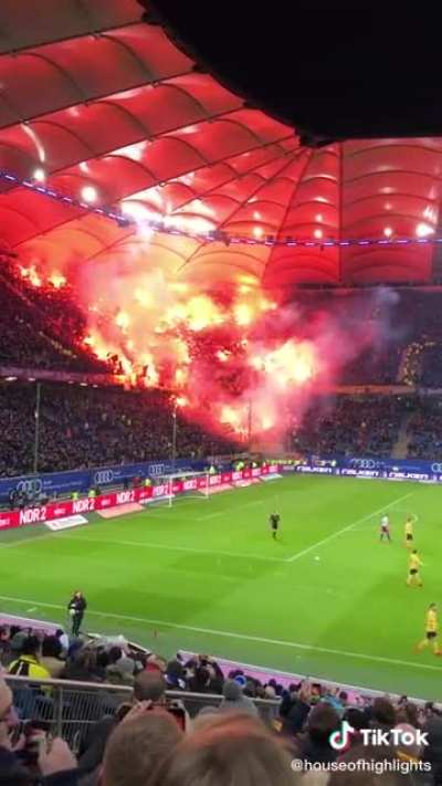 The flags look like a bunch of hands reaching out of hell, but it&rsquo;s just football fans with flares