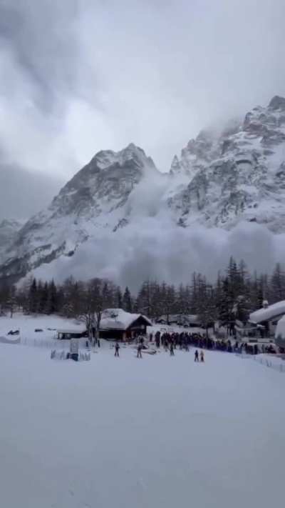 Video captured by Jean Chiementin showing a large avalanche descending toward Courmayeur's ski facilities in Italy's Aosta Valley on February 15, 2026, with crowds of skiers visible fleeing as snow clouds engulf the area