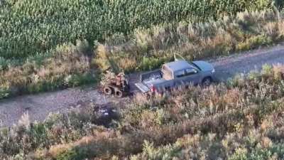 Drone footage of Vladyslav Polsky, the commander of the Ukrainian 475th Regiment "Code 9.2," rescuing two wounded soldiers with fractures left in open after an FPV drone attack on the ground evacuation drone with his own unprotected pickup truck without w