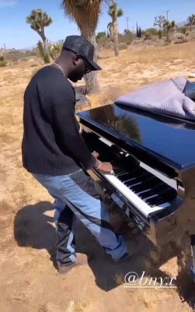 BNYX playing the melody from "Bigger Than Ever" in the same place as the music video