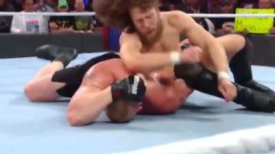 Daniel Bryan clobbering Brock Lesnar to try to grasp the Yes Lock