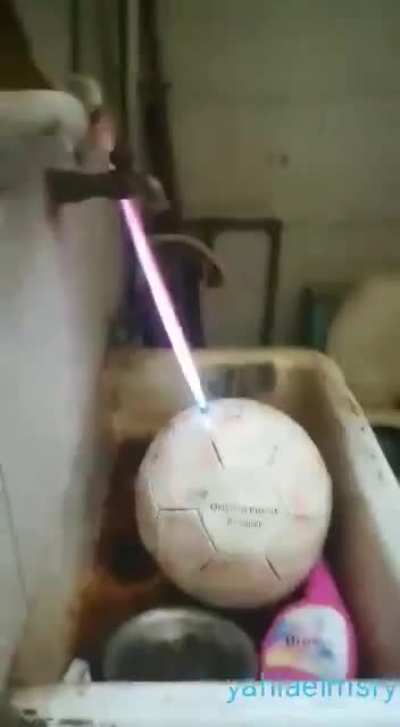 Blowing up a soccer ball.
