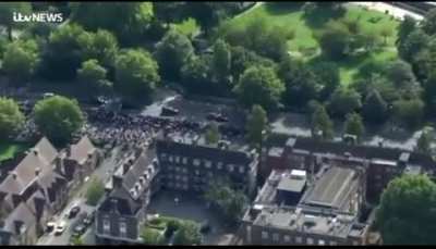 Someone says "the death is irreversible and the fact is she is trapped" during the queen's funeral procession