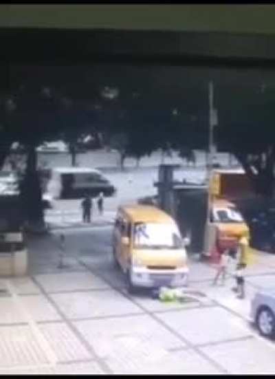 Lady trying to push a kid in front of a car and then acting like she got hit.