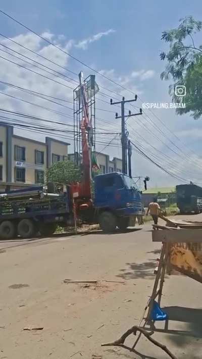 Truck with crane gets its load too close to power lines.