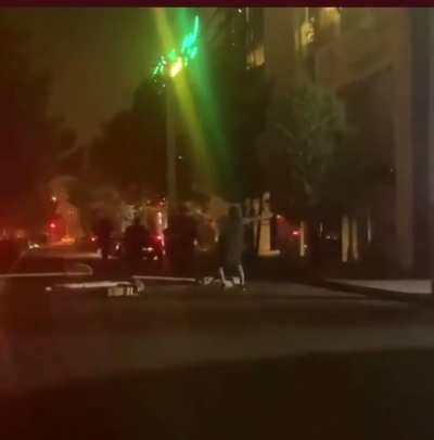 Iranian woman took off her hijab and walked toward the Islamic morality police.