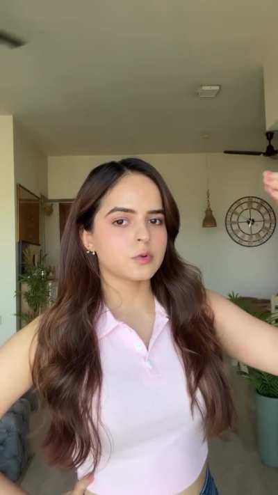 Palak Sindhwani in sleeveless pink polo shirt with buttons and blue denim jeans