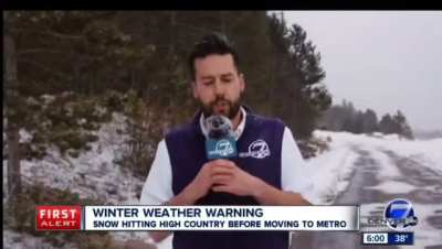 Meteorologist not enjoying his time filming a live shot in the snow.
