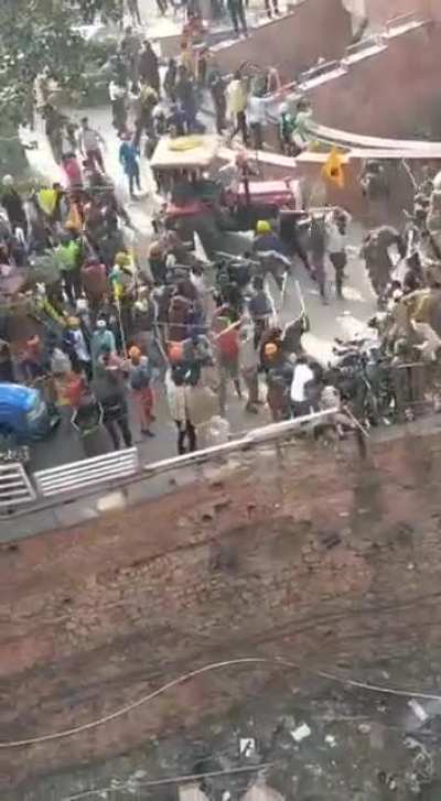 Sikh protestors throwing policemen off the wall