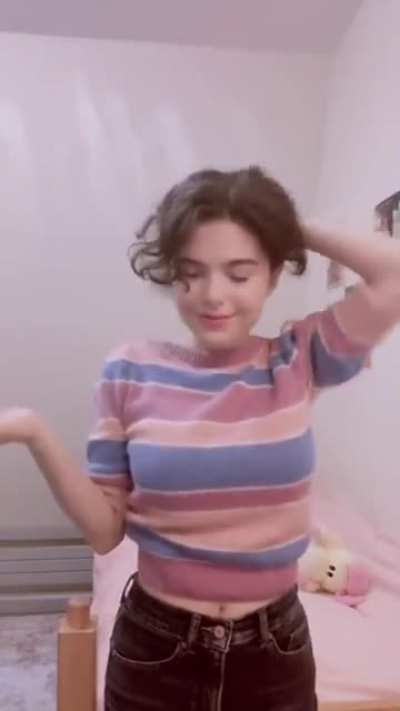 Becca adjusting her sweater
