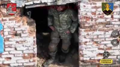 Russian soldier is trying to protect from an FPV drone by putting a washing machine water tank on his head.