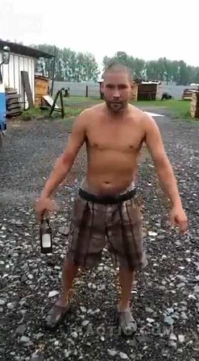 Russian Rambo attempting to break a bottle with his head.