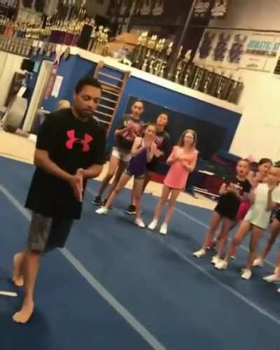 Teacher does a standing double backflip for his students .