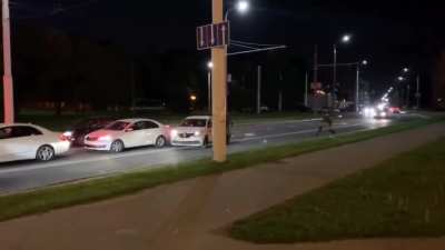 Man in Belarus escapes riot police by jumping into a taxi car which drives away instantly