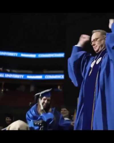 At Seton Hall University's 2023 commencement, service dog Justin received an honorary diploma for faithfully attending every class alongside his owner, Grace Mariani.