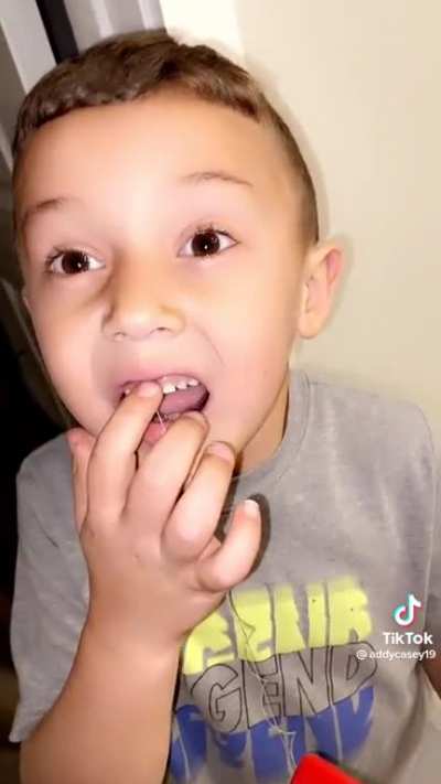 the way he tries to pull his front tooth out
