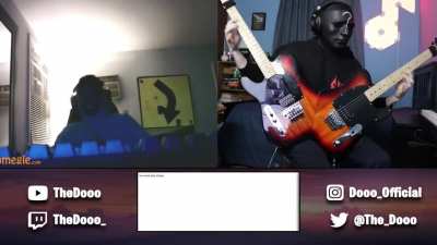 Man plays Through the Fire and The Flames on two guitars at once