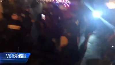 Protesters in DC yell at police, one stops in the middle of the sidewalk and cries "felony assault" as they move past him