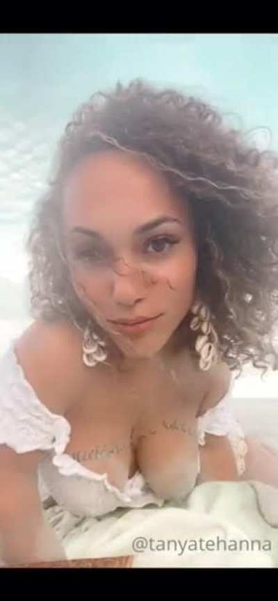 Tanya Tehanna crawls in the sand and shows her sand covered tits