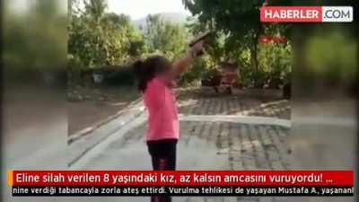 Idiot uncle forces his niece to fire a pistol and nearly gets himself killed.