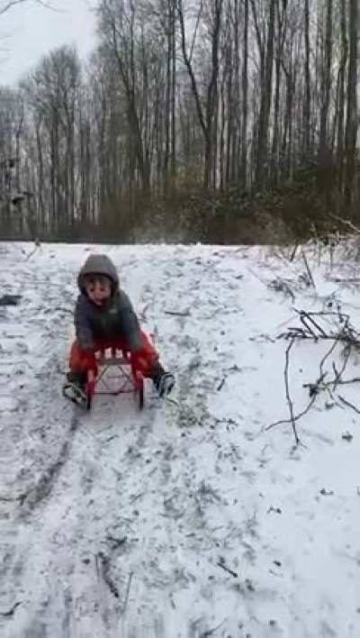 My little nephew crashing his sled