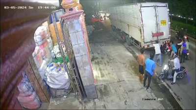 Motorcyclist wedges himself under truck