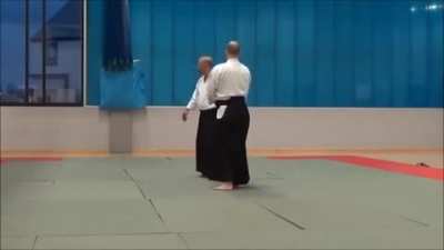 Aikido master shows students the ultimate blade defense.