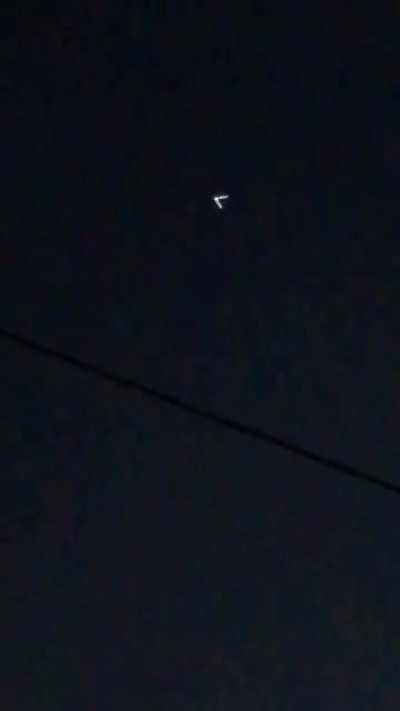 V- Shaped UFO Captured Glowing In The Night Sky