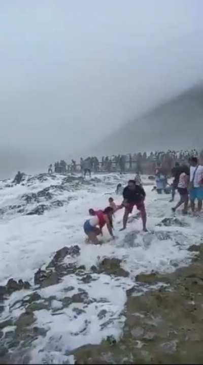 Playing near jagged rocks and rough crashing waves somehow goes wrong