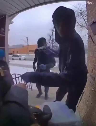 Chicago: Woman and child robbed by two armed men.