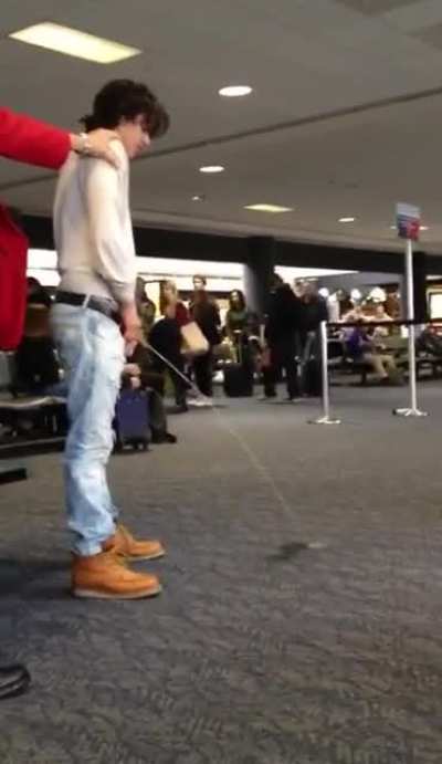 Drunk guy urinates at an airport gate.