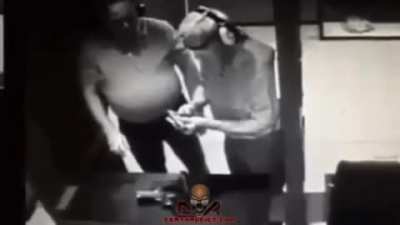 Testing a gun against his hand.