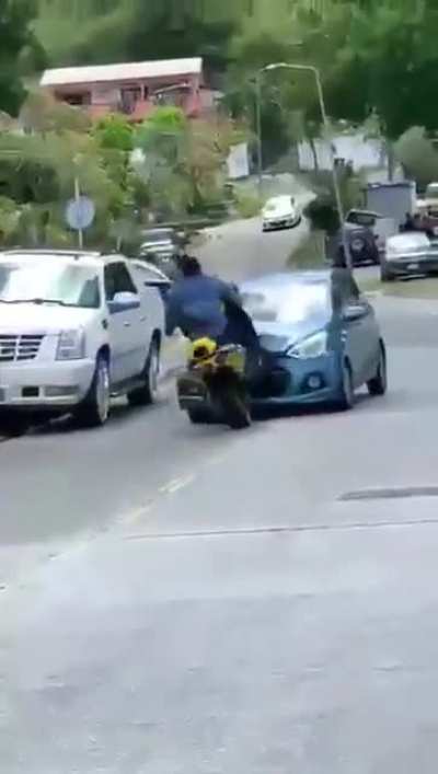 Motorcycle Rider doing a wheelie on side street