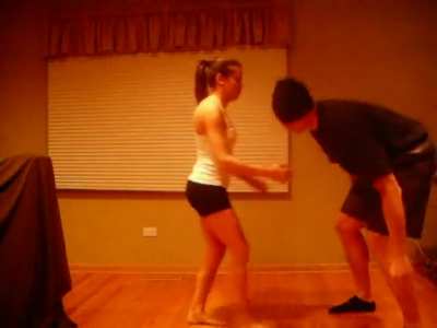 Small girl kicking a big guy in the nuts