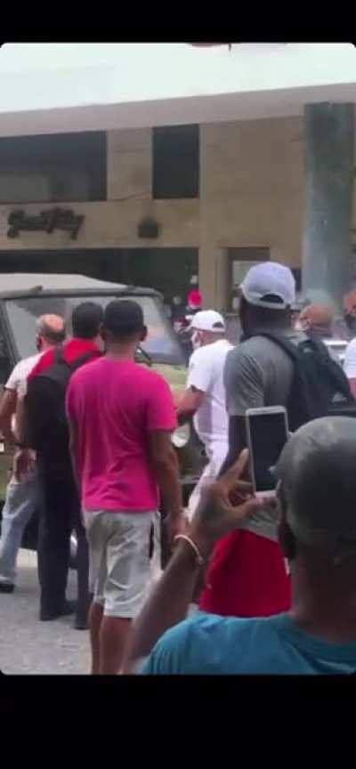 Cuban People asking for Freedom, and a Cop running away.