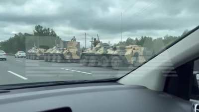Ru pov:  The situation on the highway M4 "Don" in the Moscow region, Military trucks and a dozen armored personnel carriers on the side of the highway. 