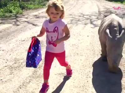 Oh this? It&rsquo;s just a girl walking with her baby rhino friend. Just keep scrolling.