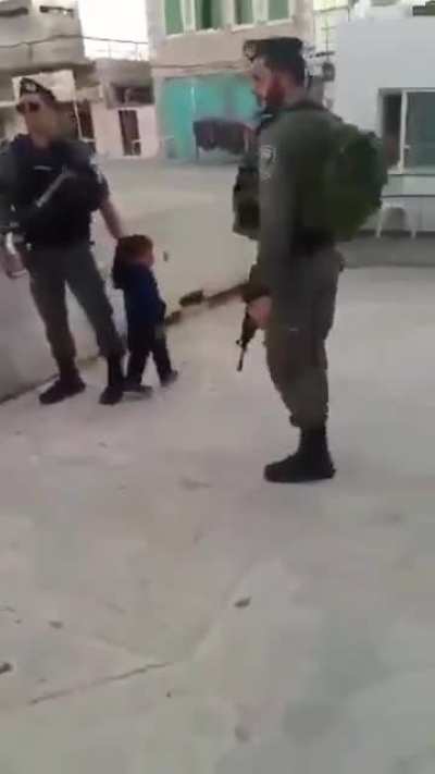 Israeli soldiers detain a 2 year old Palestinian child
