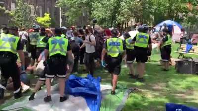 Toronto police dismantling a homeless camp