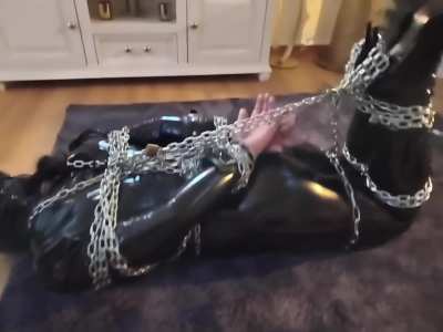 Quiet little Latex Doll wrapped tight in Chains