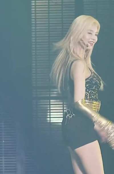 Sana - blonde, black shorts, top, gold belt, glove, dtna
