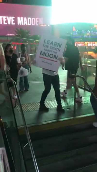Crazy guy protesting to save the moon gets drink thrown in face