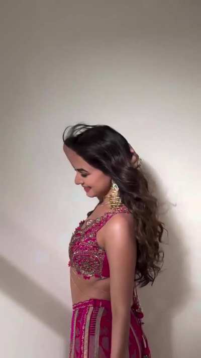 Sonal Chauhan wearing a bright pink embroidered lehenga set with intricate gold embellishments and statement dangling earrings. Sonal Chauhan,outfit is by &ldquo;AUM by Ashima &amp; Asit&rdquo; and her jewellery is from Curio Cottage.