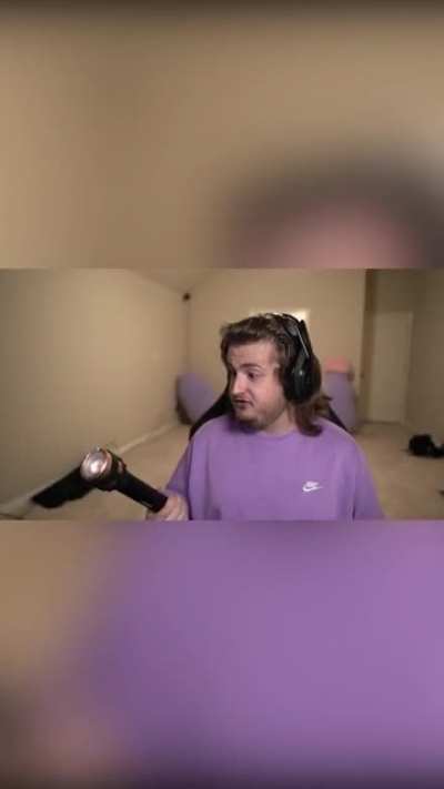 Purplecliffe looks into his costco flashlight