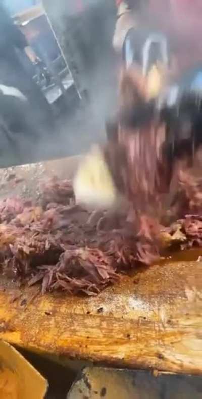 Efficiently slicing some delicious BBQ'd pork.